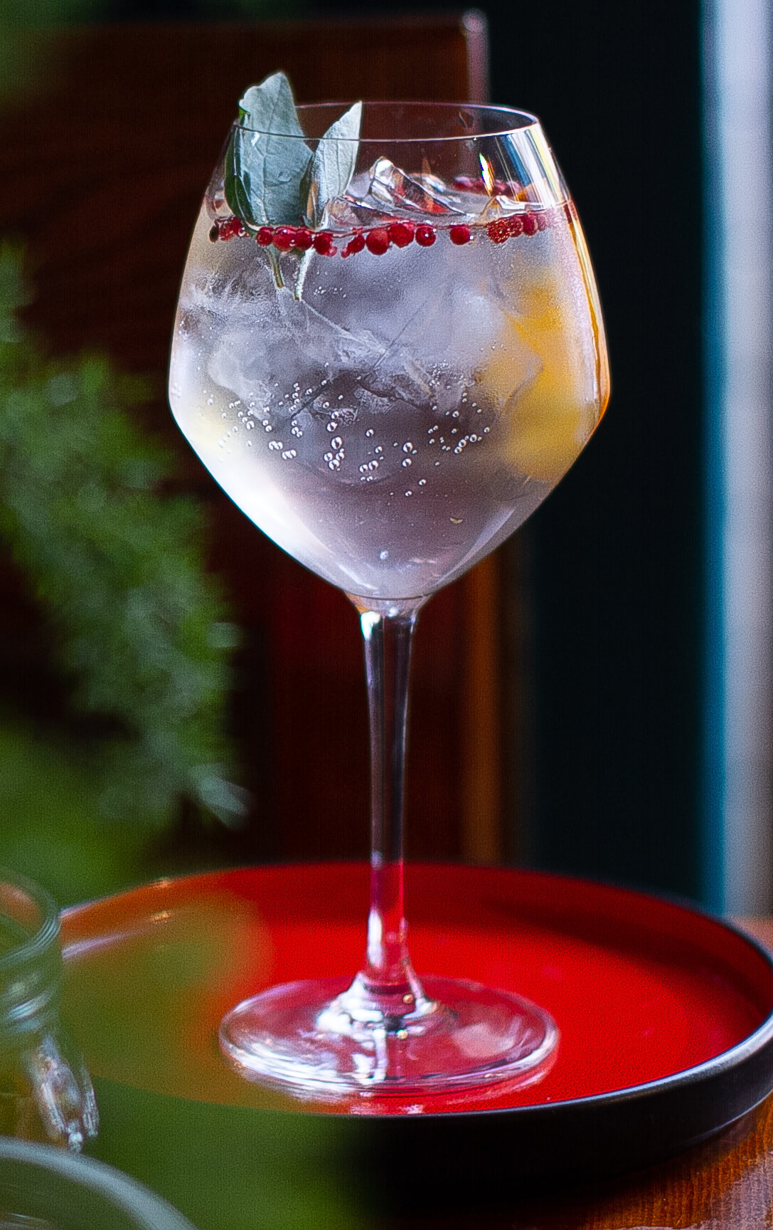 Method and Madness G-T served in a goblet glass with juniper berries and basil