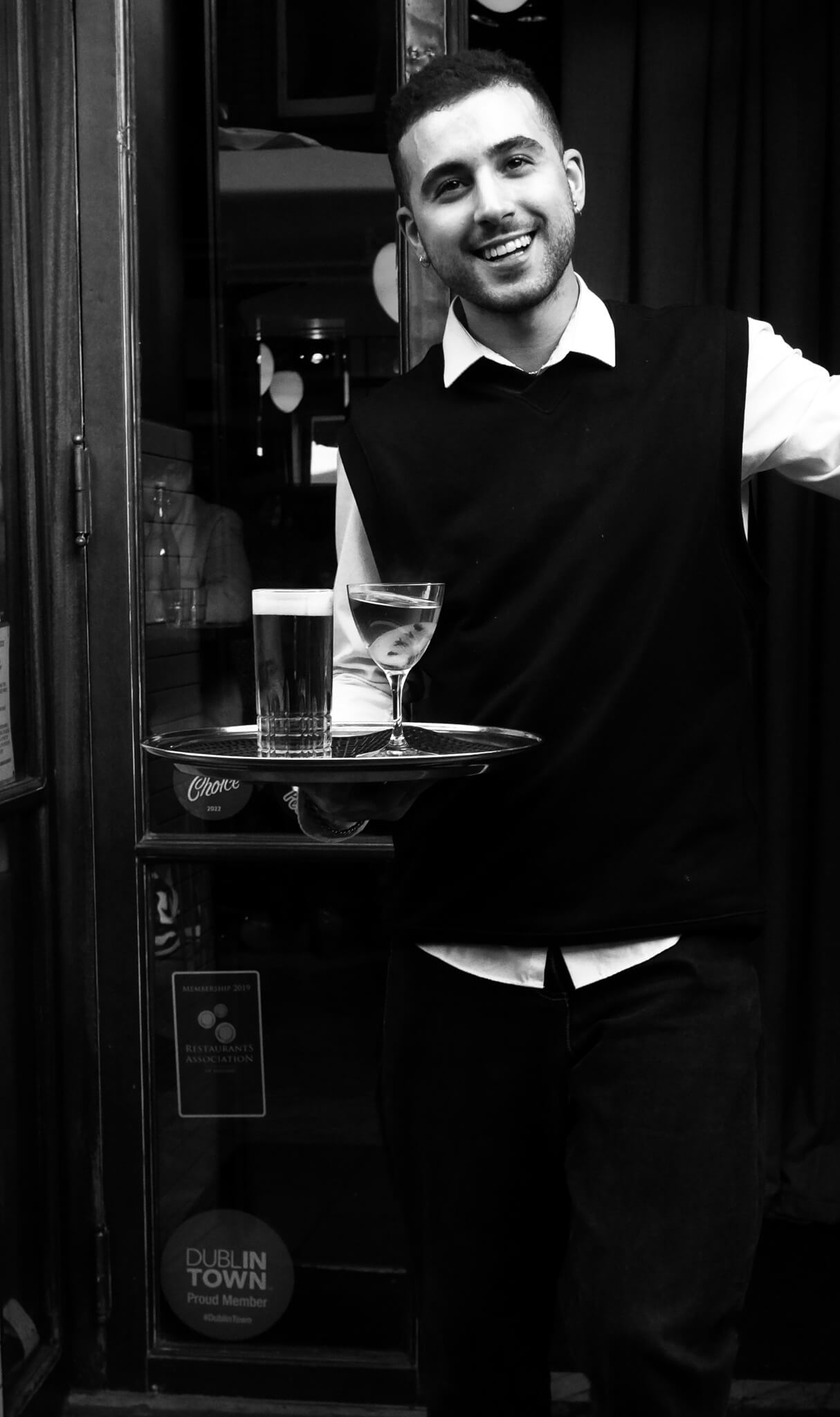 A waiter serving drinks on a tray